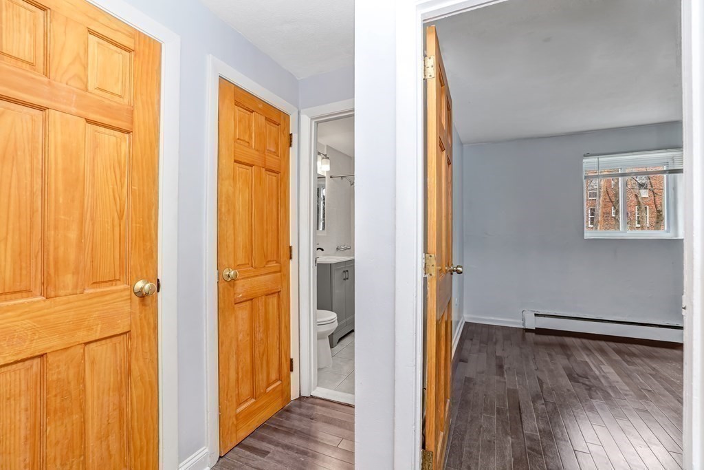 10 Bryon Road, Unit 4 Boston, MA 02467 - Photo 9 of 27 a view of front door with wooden floor