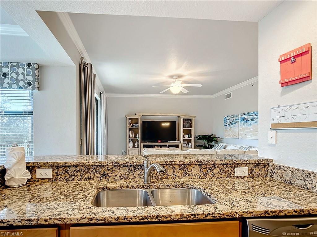 9715 Acqua Court, Unit 127 Naples, FL 34113 - Photo 17 of 50 a bathroom with a granite countertop sink and a mirror