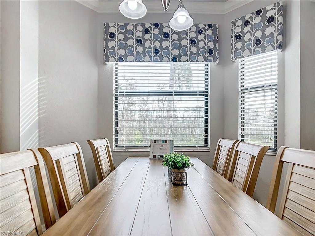 9715 Acqua Court, Unit 127 Naples, FL 34113 - Photo 20 of 50 a view of a dining room with furniture window and wooden floor