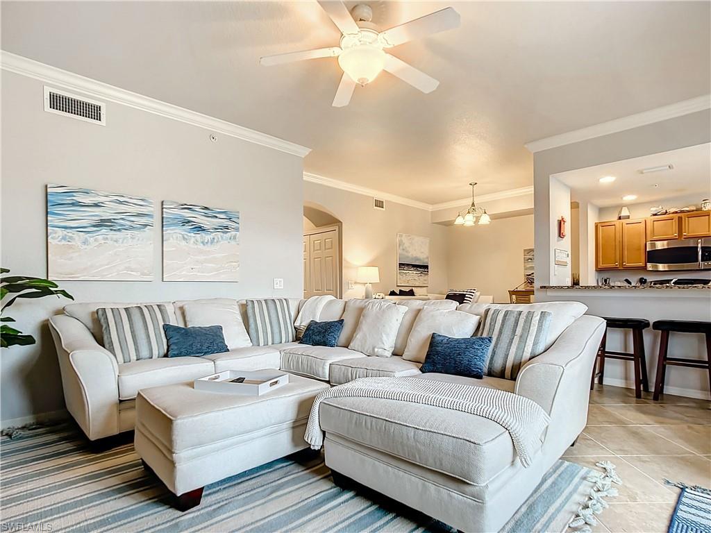 9715 Acqua Court, Unit 127 Naples, FL 34113 - Photo 26 of 50 a living room with furniture and a large window