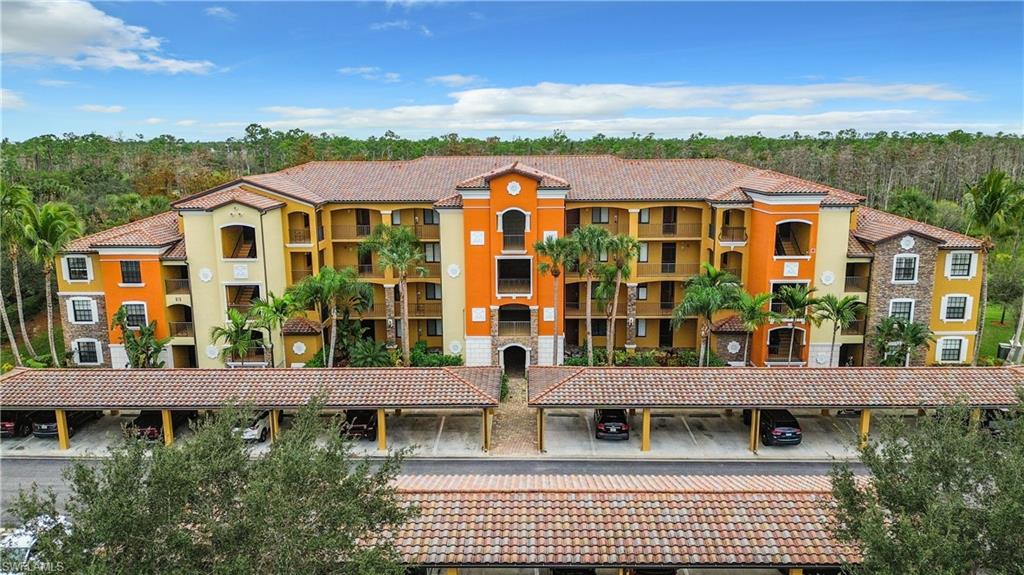 9715 Acqua Court, Unit 127 Naples, FL 34113 - Photo 3 of 50 a view of multiple houses with a yard