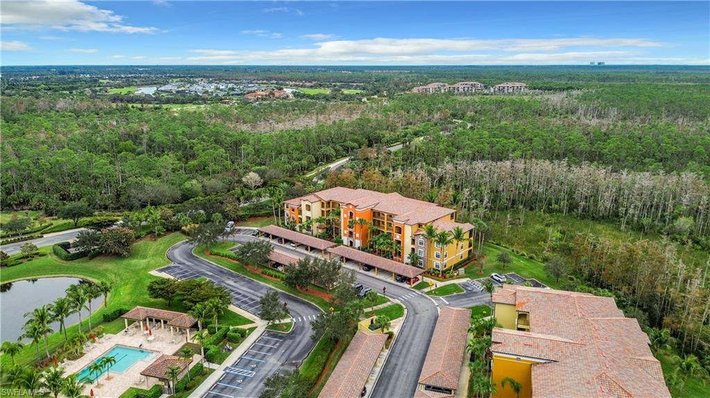 9715 Acqua Court, Unit 127 Naples, FL 34113 - Photo 4 of 50 an aerial view of a house with a garden and lake view