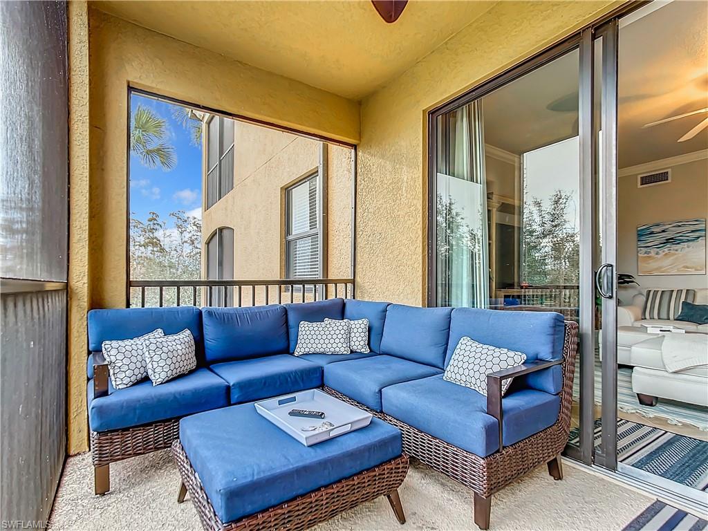 9715 Acqua Court, Unit 127 Naples, FL 34113 - Photo 43 of 50 a living room with furniture and a large window