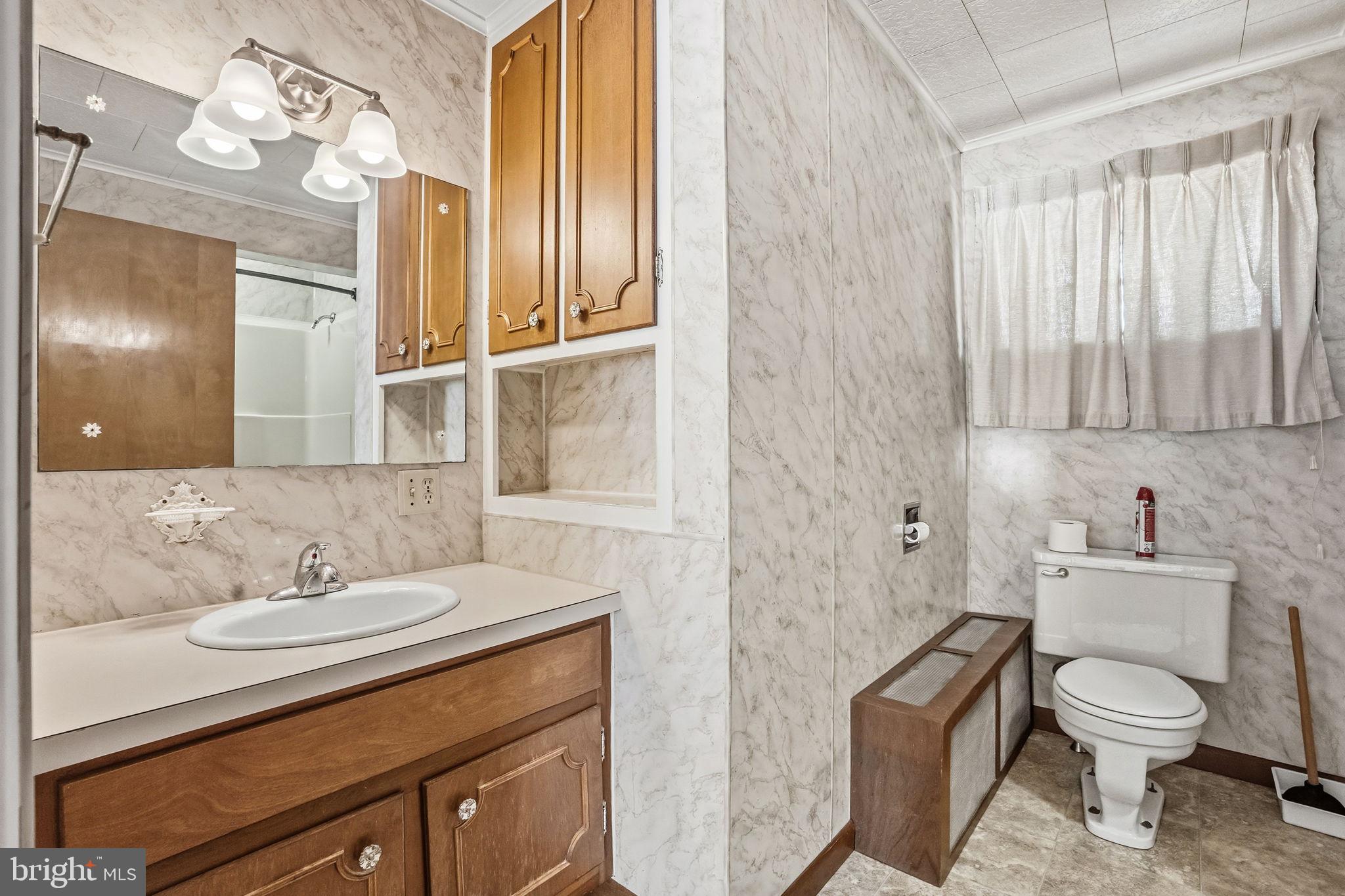 610 East Market Street Beavertown, PA 17813 - Photo 17 of 46 a bathroom with a sink a toilet and a mirror