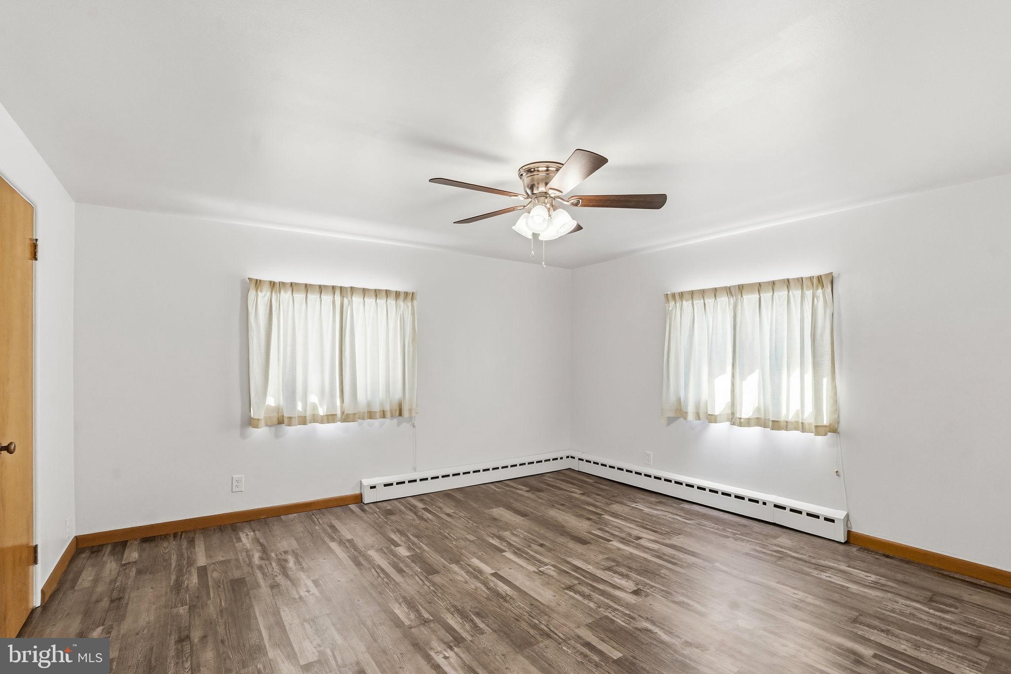 610 East Market Street Beavertown, PA 17813 - Photo 19 of 46 a view of an empty room with wooden floor and a window
