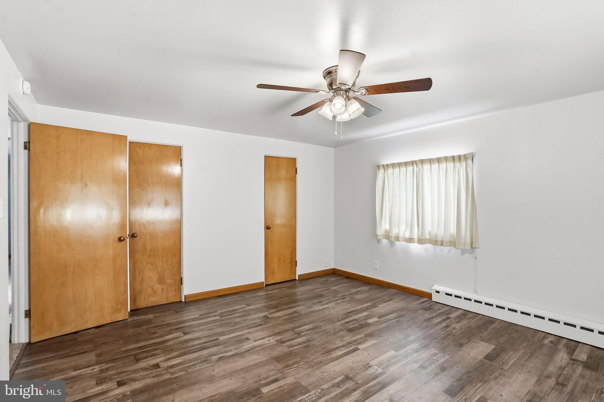 610 East Market Street Beavertown, PA 17813 - Photo 20 of 46 a view of an empty room with wooden floor and window