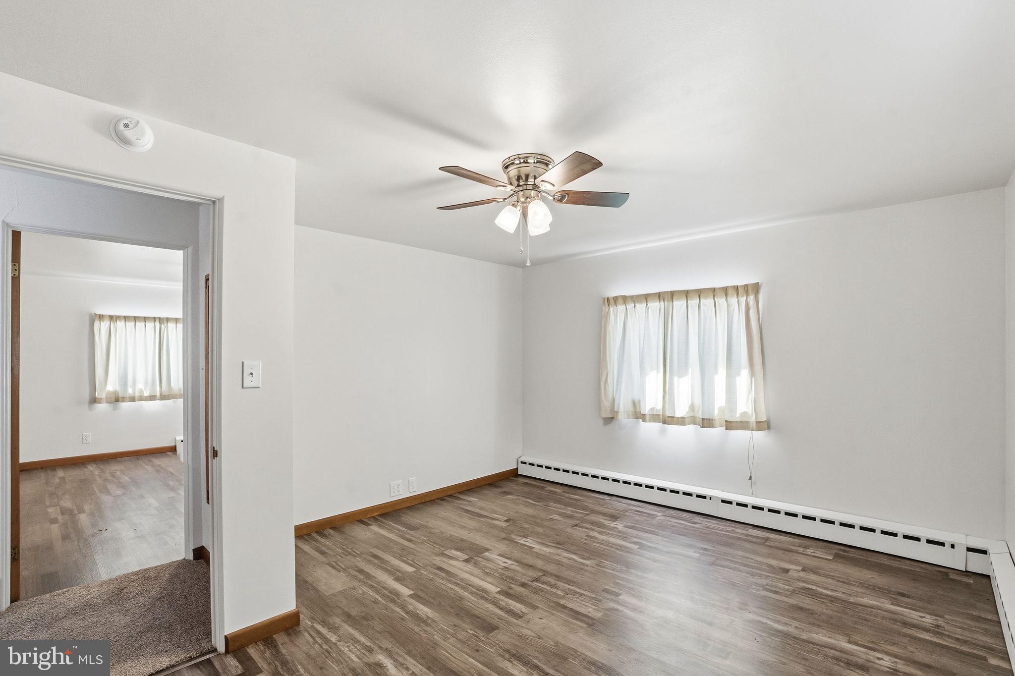 610 East Market Street Beavertown, PA 17813 - Photo 23 of 46 wooden floor in an empty room with a window