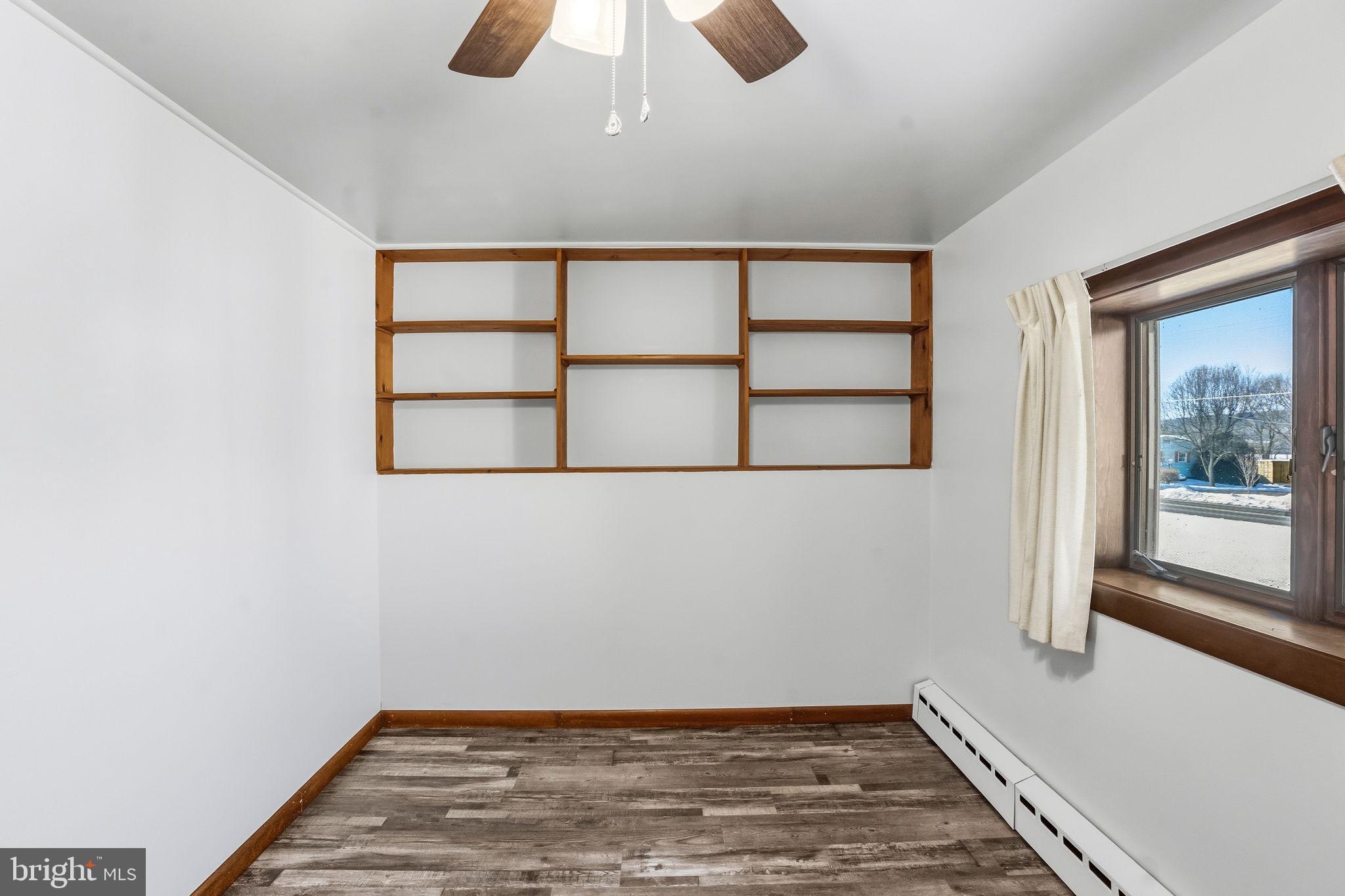 610 East Market Street Beavertown, PA 17813 - Photo 27 of 46 an empty room with wooden floor and windows