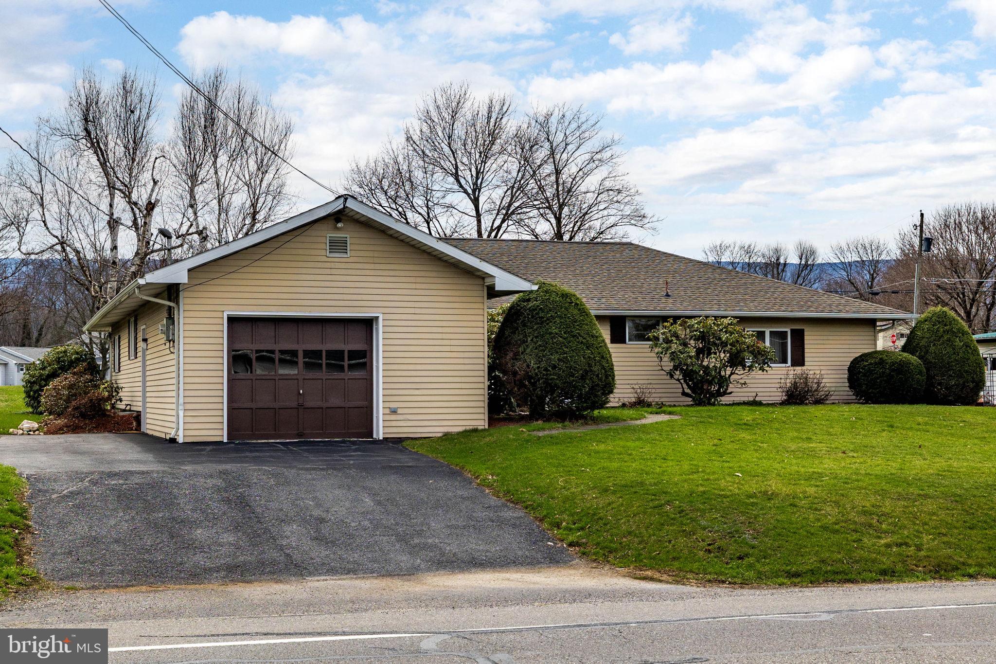 610 East Market Street Beavertown, PA 17813 - Photo 35 of 46 a view of a house with a yard and garage