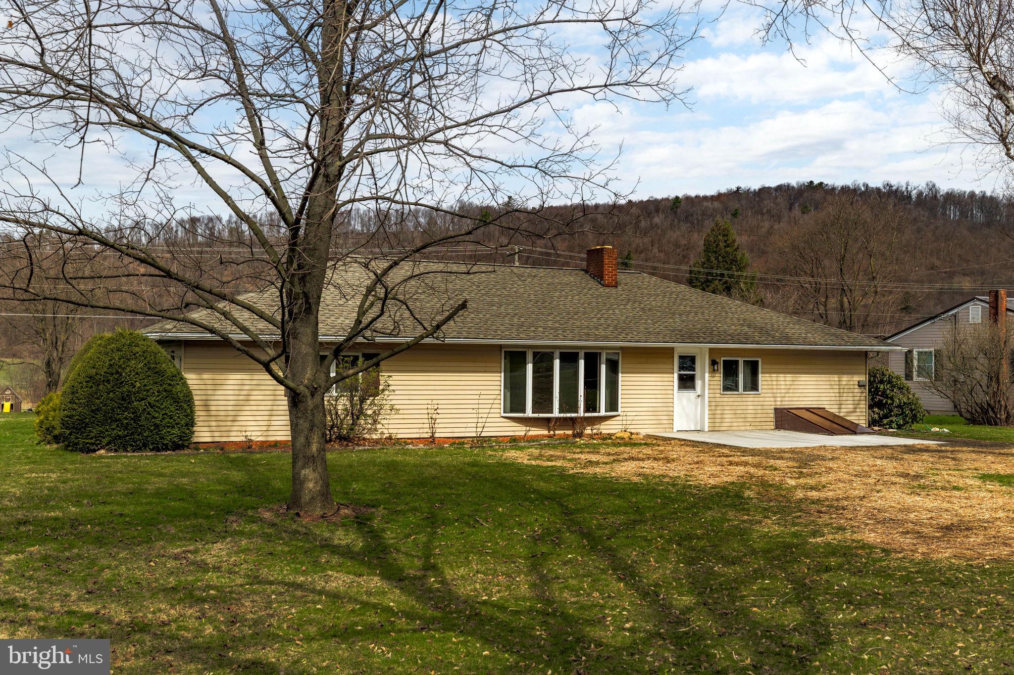 610 East Market Street Beavertown, PA 17813 - Photo 38 of 46 a front view of house with yard and green space