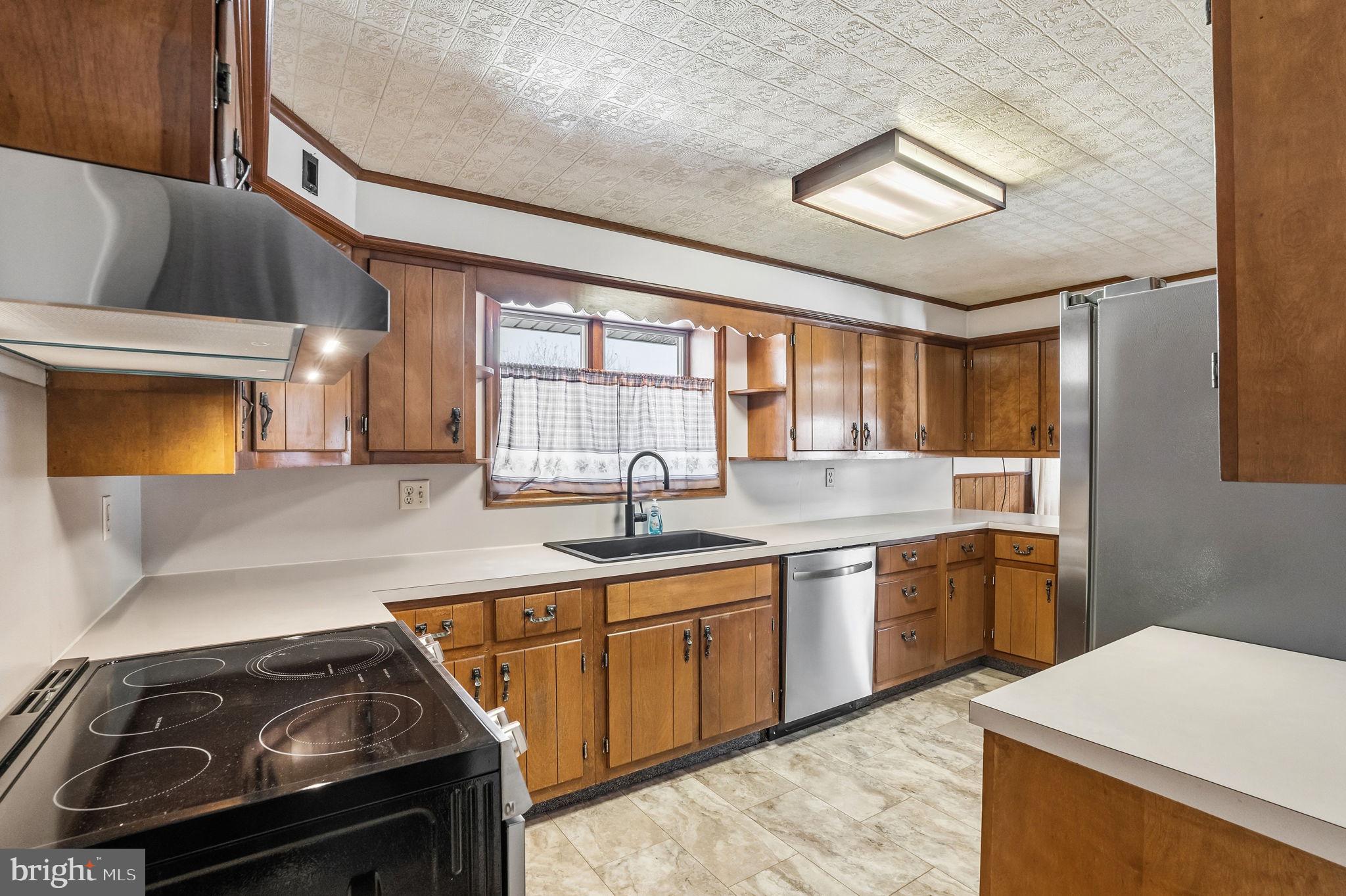 610 East Market Street Beavertown, PA 17813 - Photo 5 of 46 a kitchen with a sink stove and cabinets
