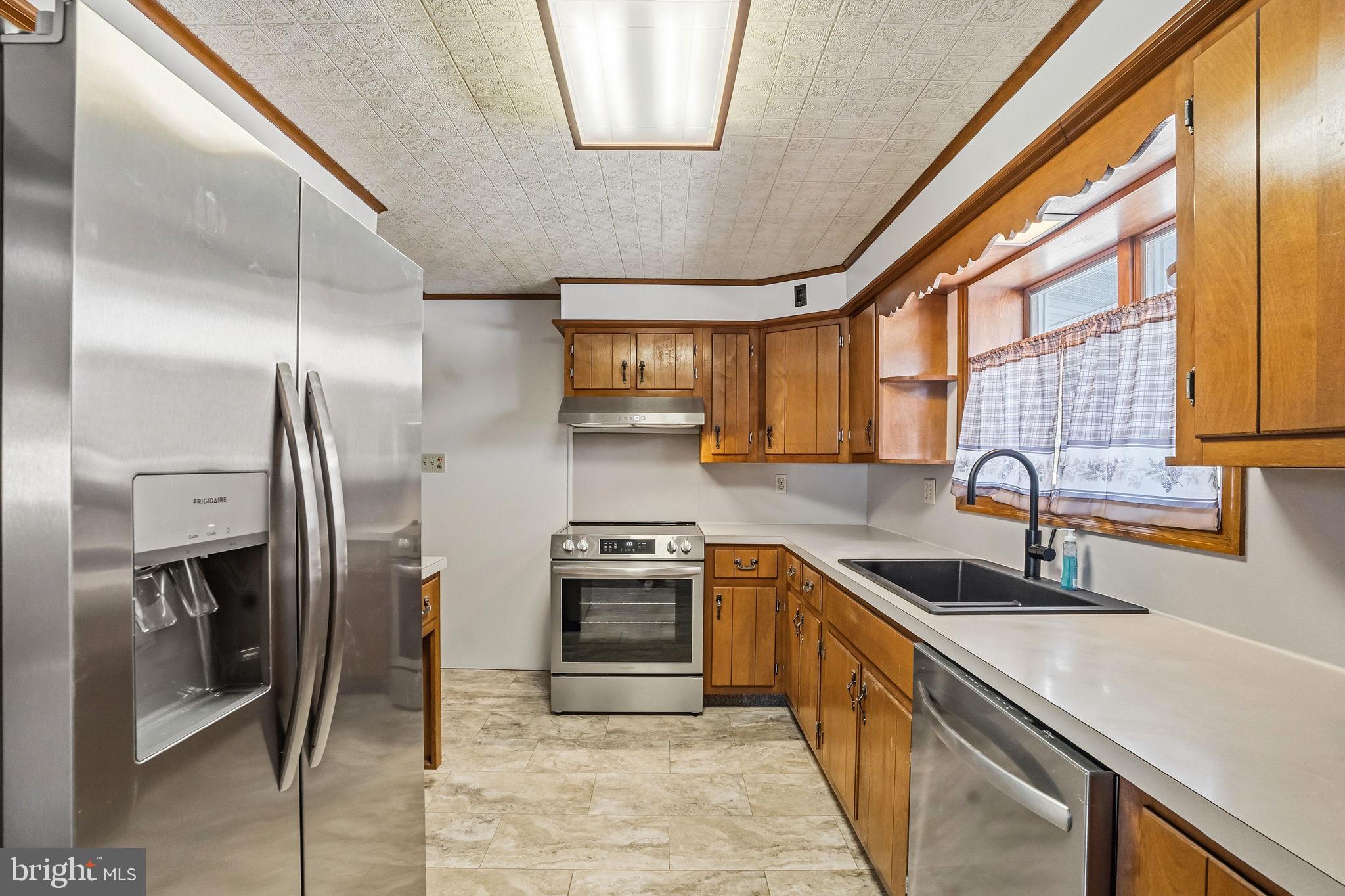 610 East Market Street Beavertown, PA 17813 - Photo 7 of 46 a kitchen with stainless steel appliances granite countertop a sink a stove and a refrigerator