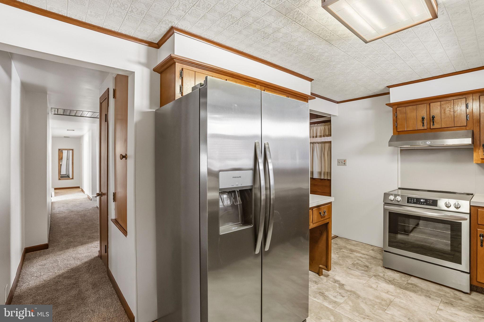 610 East Market Street Beavertown, PA 17813 - Photo 9 of 46 a kitchen with stainless steel appliances granite countertop a refrigerator and a stove