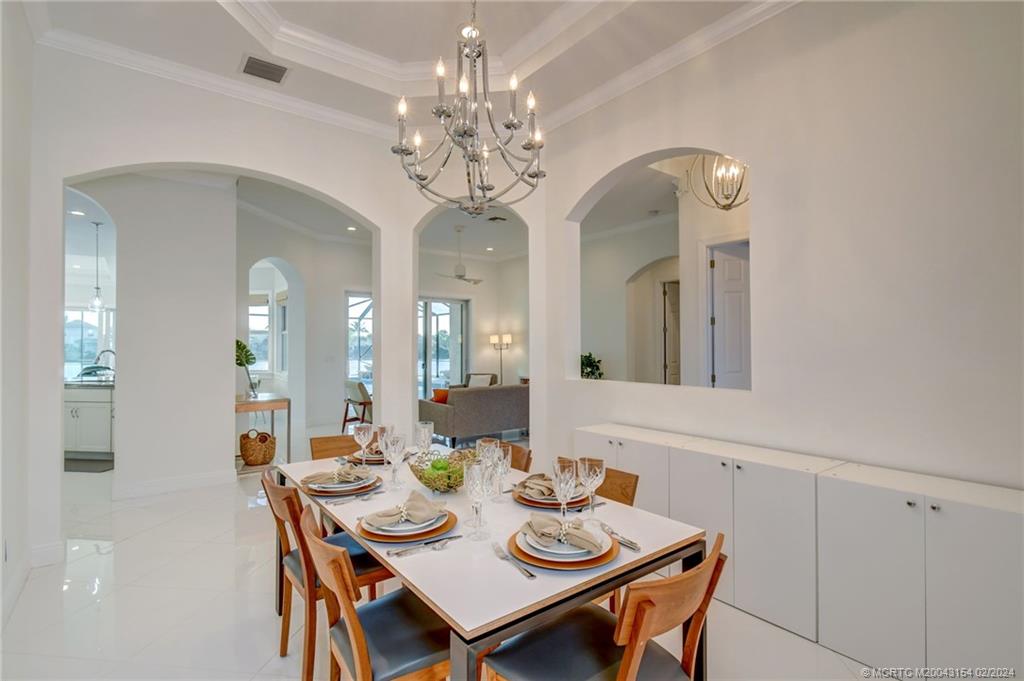 7172 Southeast Pierre Circle Stuart, FL 34997 - Photo 11 of 43 a view of a dining room with furniture and a chandelier