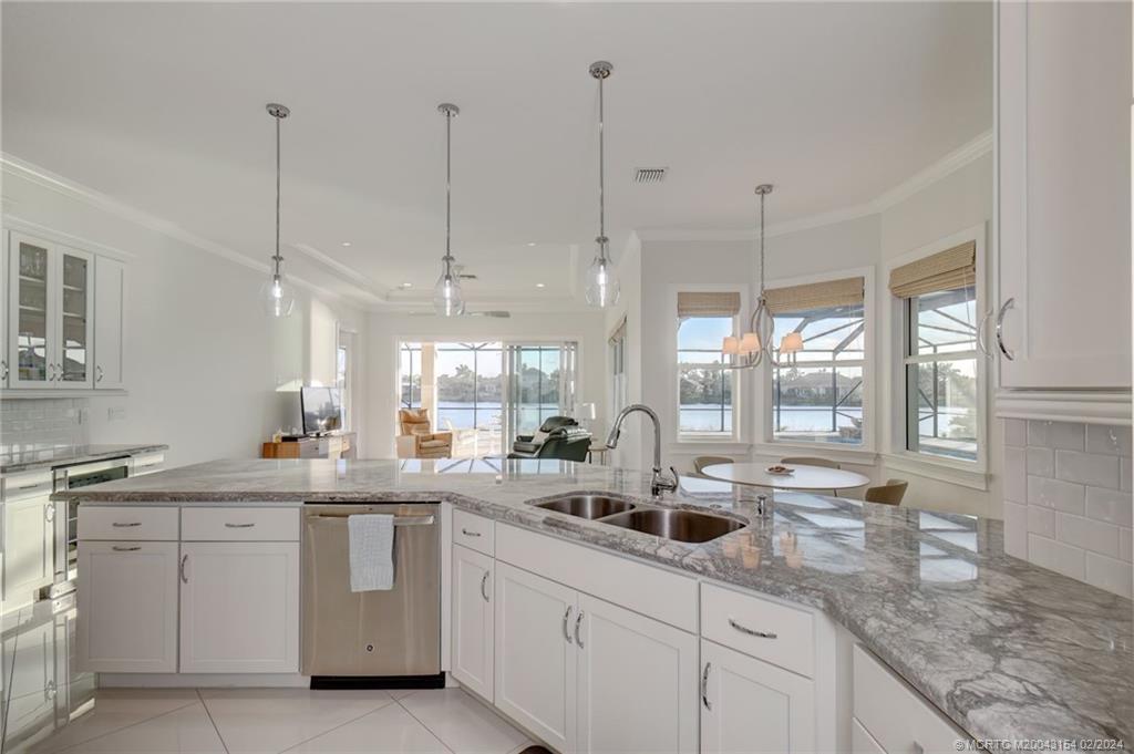 7172 Southeast Pierre Circle Stuart, FL 34997 - Photo 12 of 43 a kitchen with sink cabinets and window