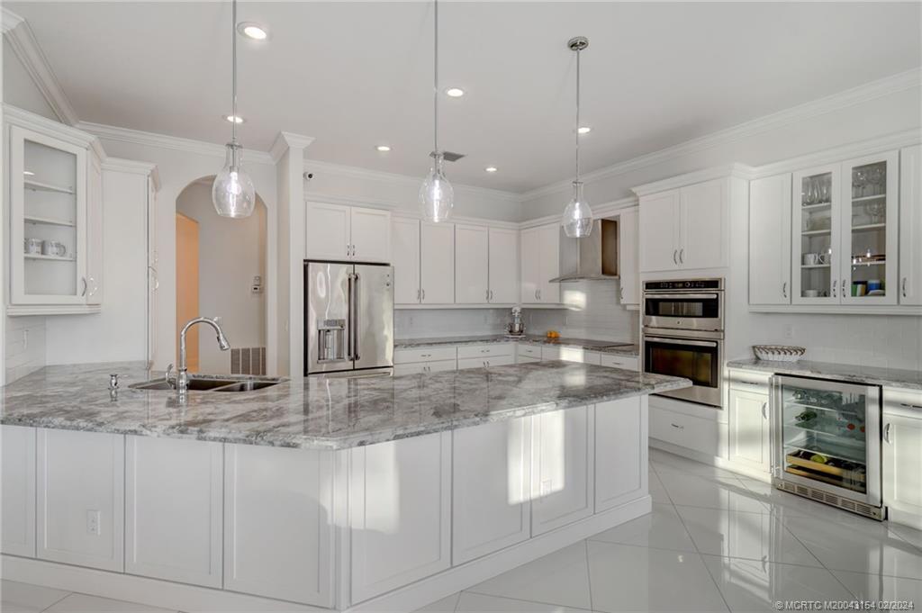 7172 Southeast Pierre Circle Stuart, FL 34997 - Photo 13 of 43 a kitchen with stainless steel appliances granite countertop a stove oven and a refrigerator