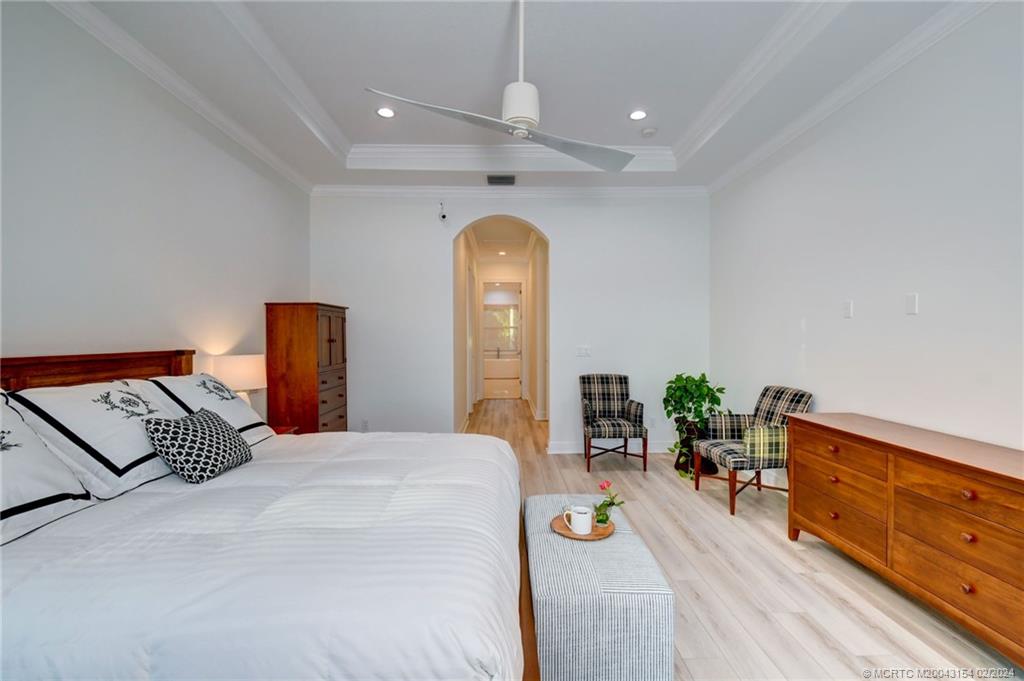 7172 Southeast Pierre Circle Stuart, FL 34997 - Photo 21 of 43 a bedroom with a bed and a dresser