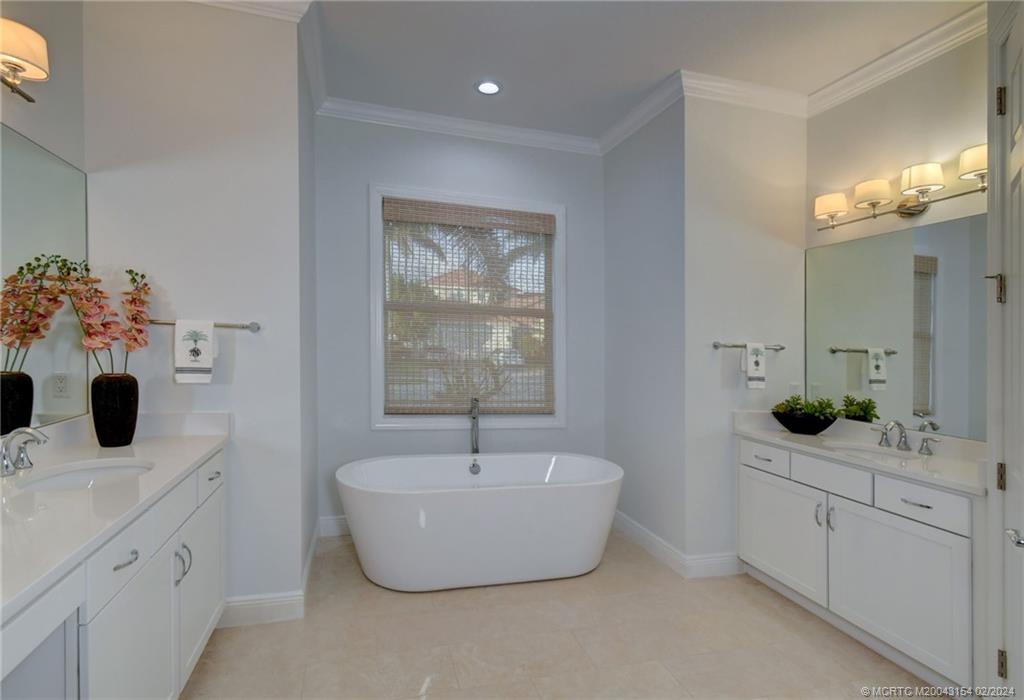 7172 Southeast Pierre Circle Stuart, FL 34997 - Photo 22 of 43 a bathroom with a bathtub sink and mirror