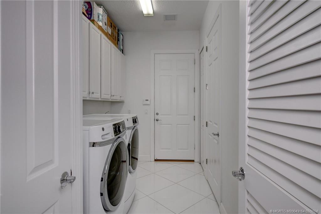 7172 Southeast Pierre Circle Stuart, FL 34997 - Photo 25 of 43 a utility room with dryer and washer