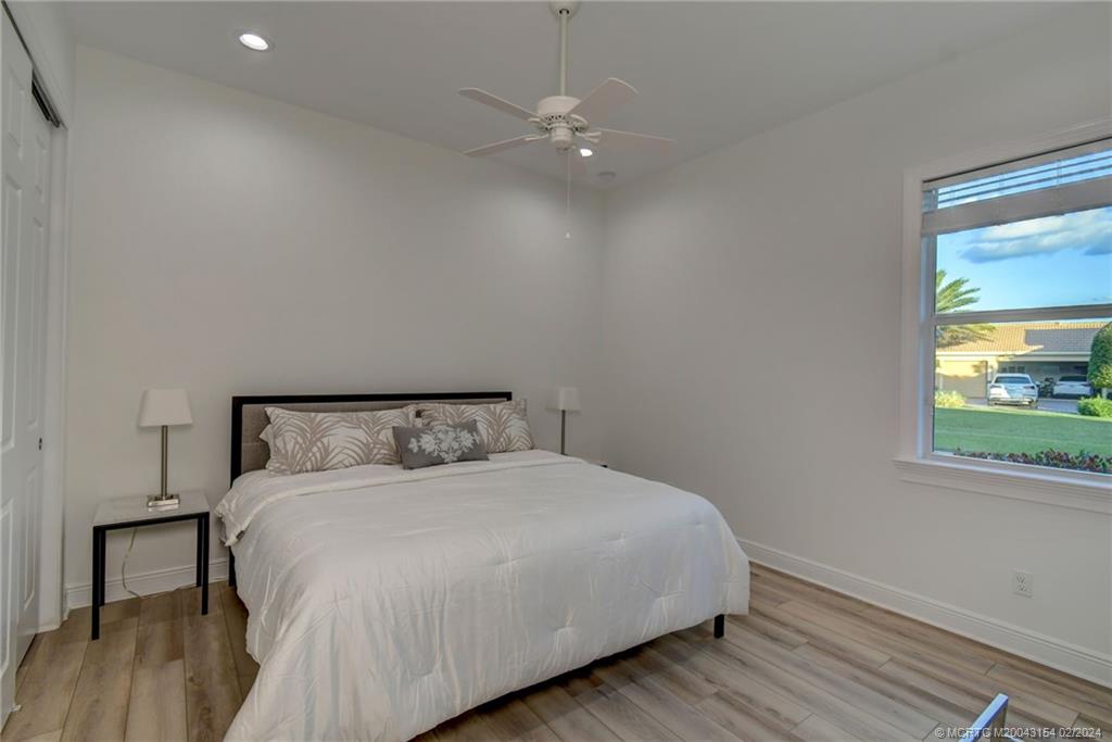 7172 Southeast Pierre Circle Stuart, FL 34997 - Photo 26 of 43 a bedroom with a bed and a window