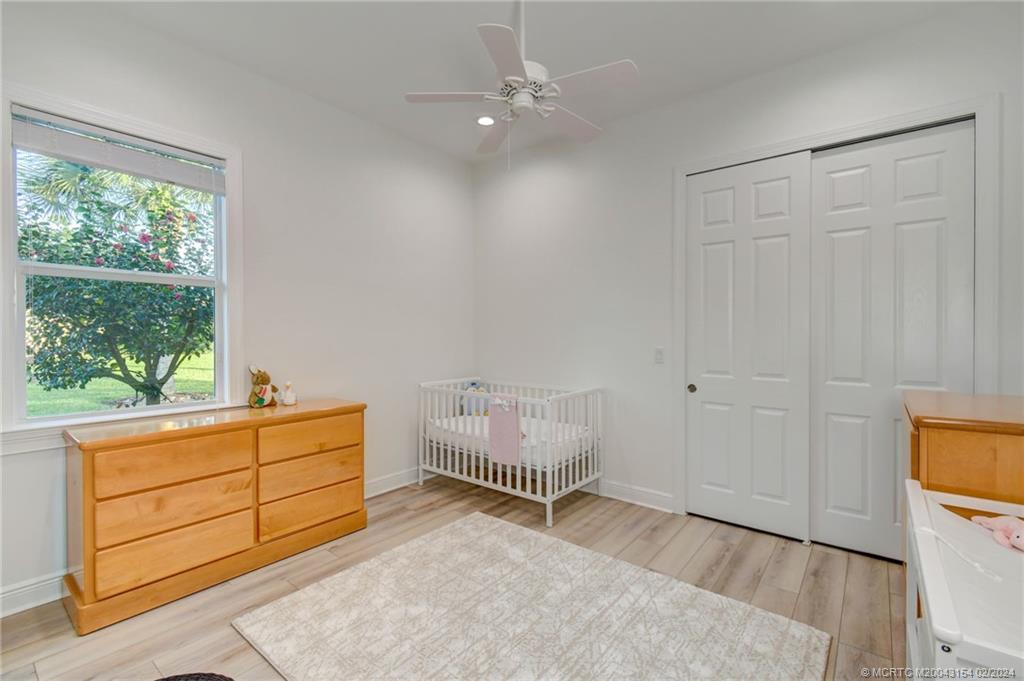 7172 Southeast Pierre Circle Stuart, FL 34997 - Photo 29 of 43 a room with a dresser and a window