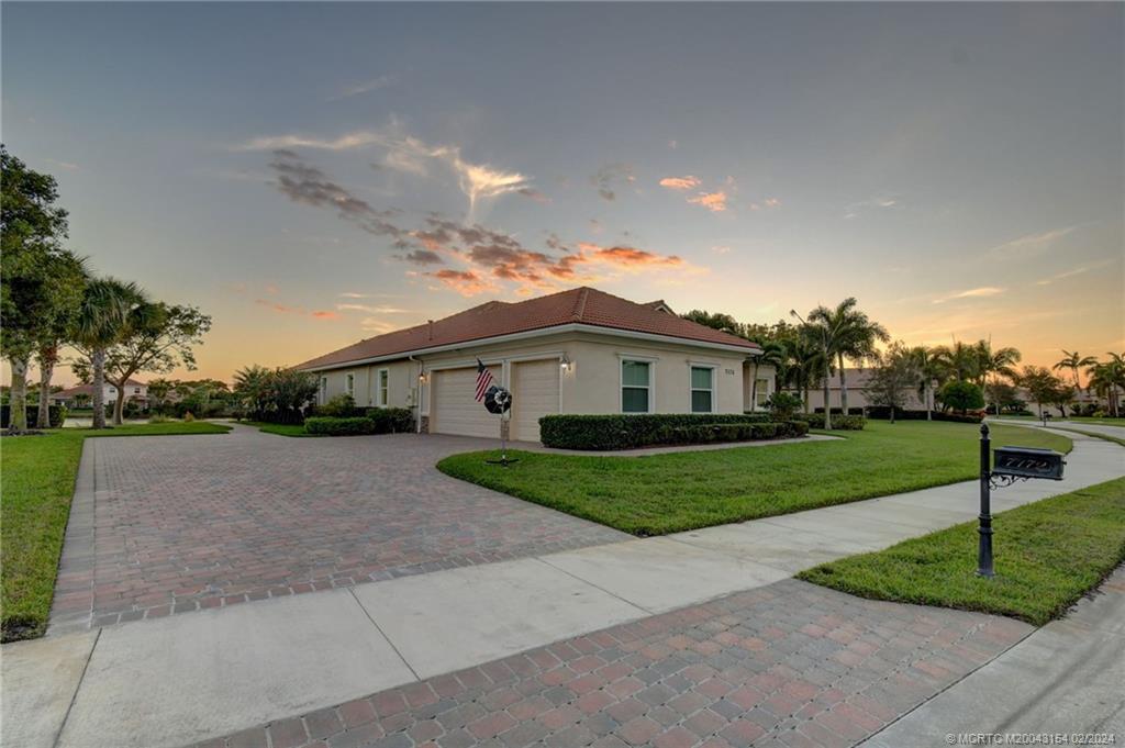 7172 Southeast Pierre Circle Stuart, FL 34997 - Photo 30 of 43 a front view of a house with a yard and garage