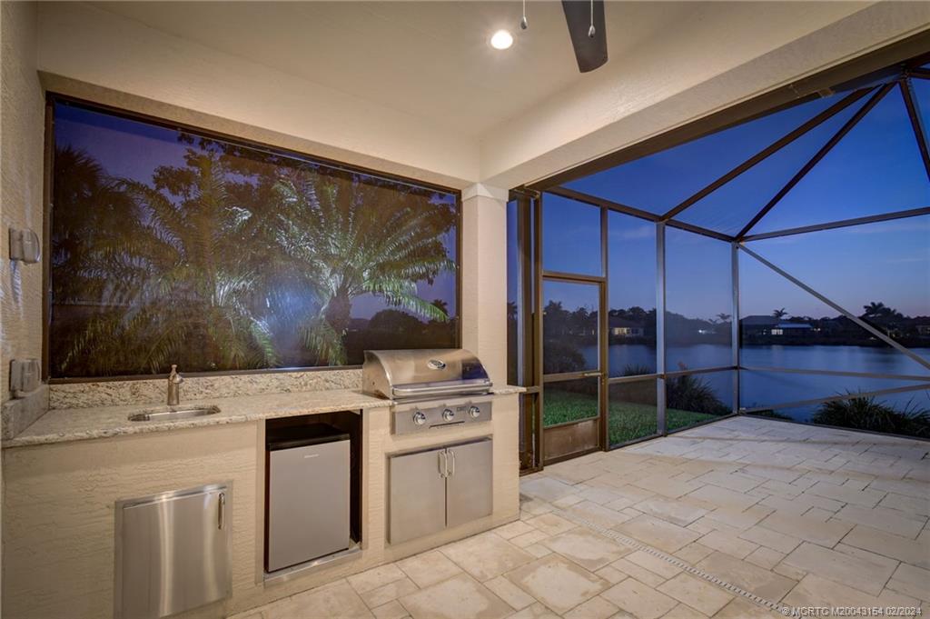 7172 Southeast Pierre Circle Stuart, FL 34997 - Photo 37 of 43 a kitchen with a stove a sink and a refrigerator