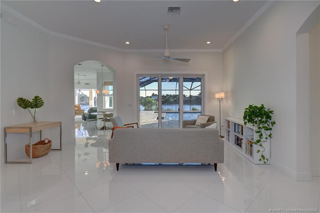 7172 Southeast Pierre Circle Stuart, FL 34997 - Photo 6 of 43 a living room with furniture and flowers