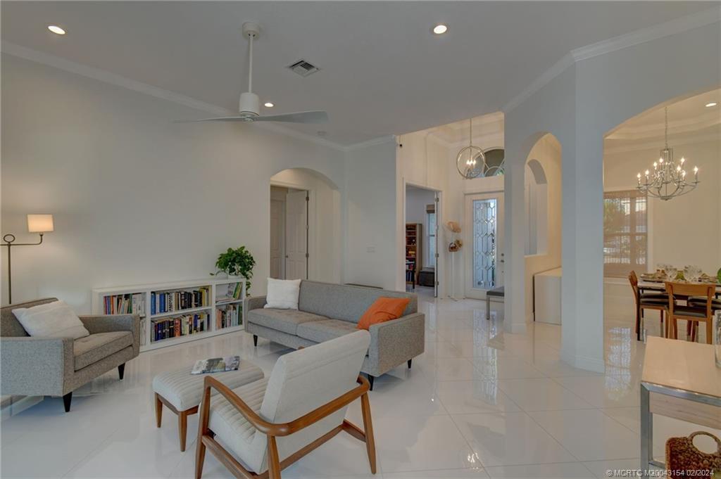 7172 Southeast Pierre Circle Stuart, FL 34997 - Photo 8 of 43 a living room with furniture and a chandelier