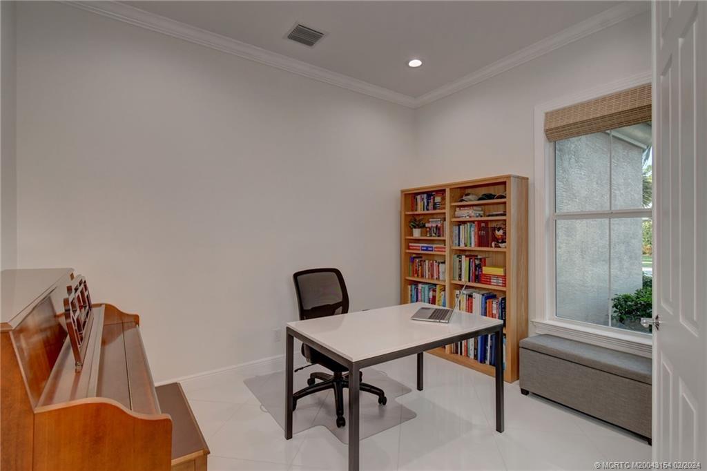 7172 Southeast Pierre Circle Stuart, FL 34997 - Photo 9 of 43 a view of a workspace with furniture and a potted plant