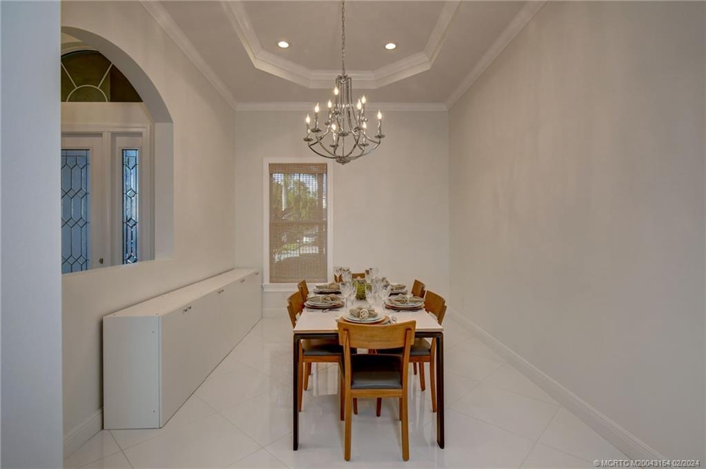 7172 Southeast Pierre Circle Stuart, FL 34997 - Photo 10 of 43 a view of a dining room with furniture and chandelier