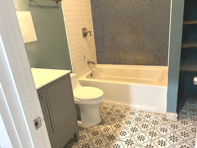 a kitchen with kitchen island sink stove and refrigerator