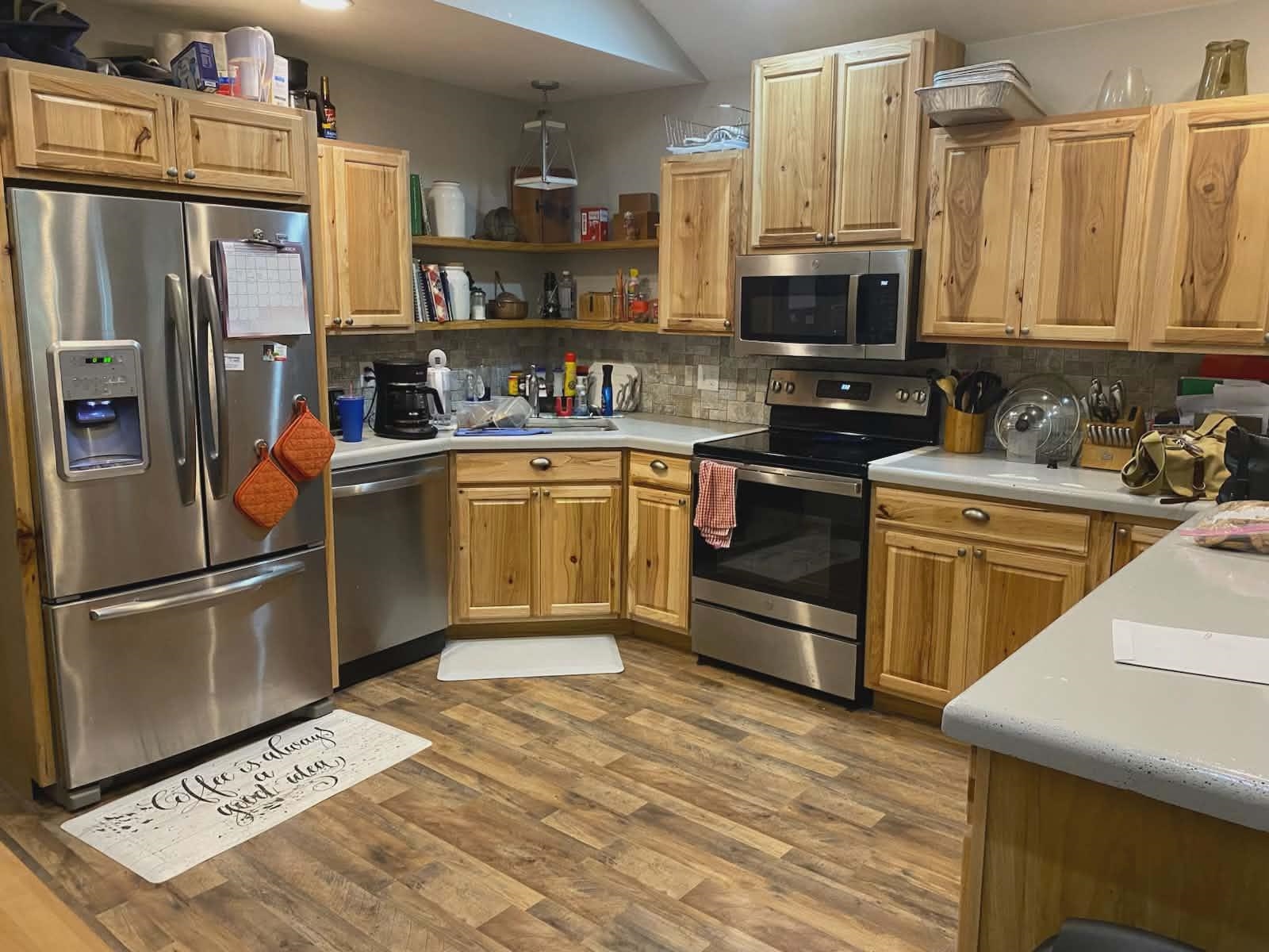 67 Cr 306 Road Iuka, MS 38852 - Photo 3 of 23 Kitchen featuring stainless steel appliances, light countertops, open shelves, and dark wood finished floors