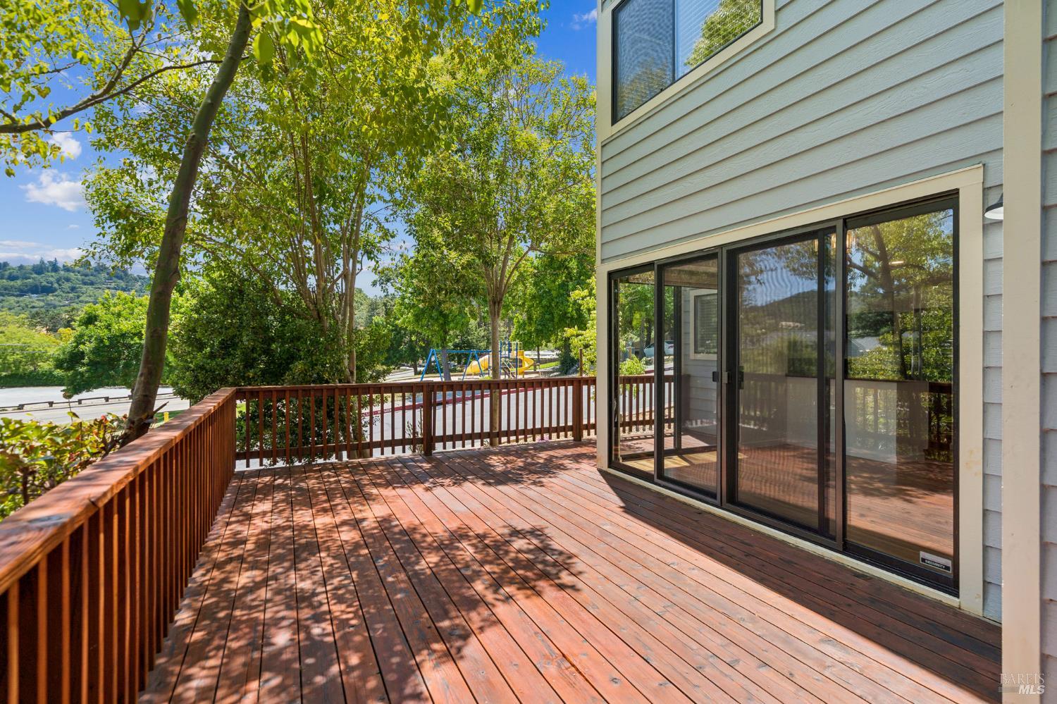 a balcony with view of trees in front of it