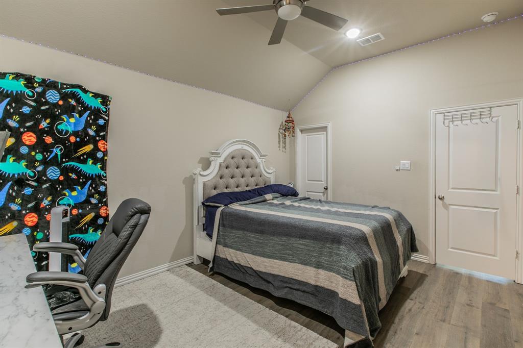 2521 Maidenhair Road Frisco, TX 75033 - Photo 24 of 39 Bedroom featuring vaulted ceiling, wood-finish flooring, and two panel doors
