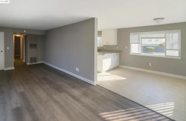 a view of a kitchen with wooden floor and a kitchen