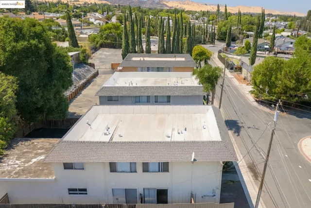 a view of a building with couches and wooden floor