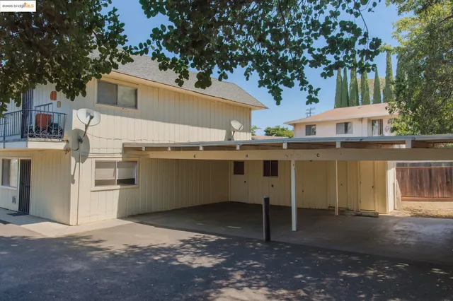 a backyard of a house with table and chairs