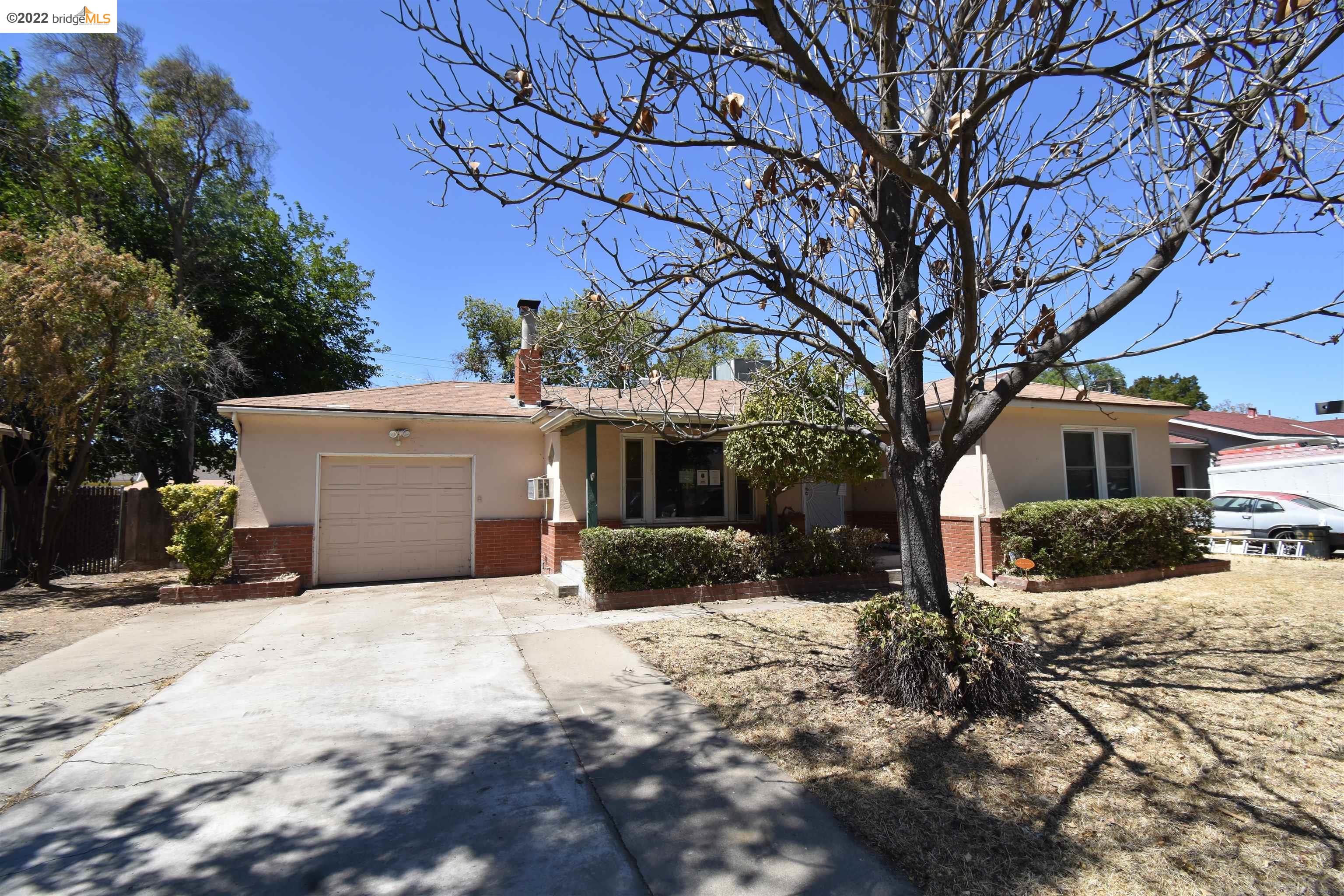 a front view of a house with a yard covered in snow