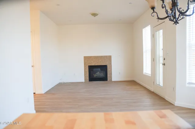 a view of empty room with fireplace