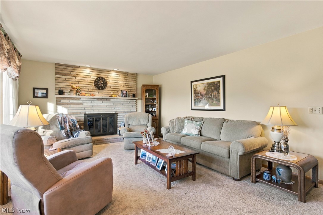 1211 Etter Road Mogadore, OH 44260 - Photo 21 of 48 Textured stone-faced fireplace with a hearth, mantel, and black firebox