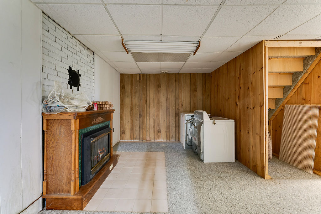 100 Nichols Ridge Road Seaman, OH 45679 - Photo 34 of 43 This versatile basement space offers a fireplace and integrated laundry facilities.