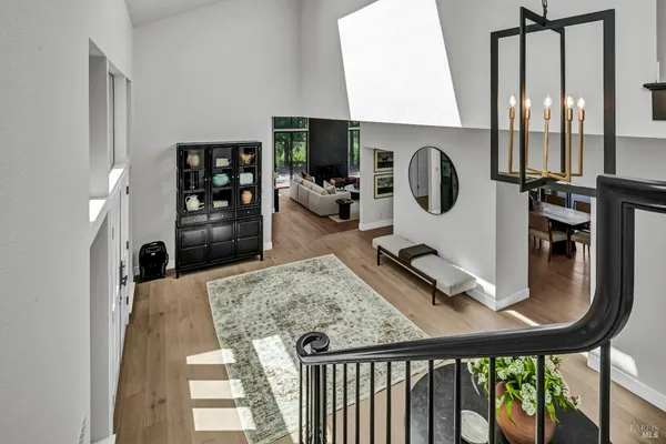 a living room with furniture large window and a fireplace