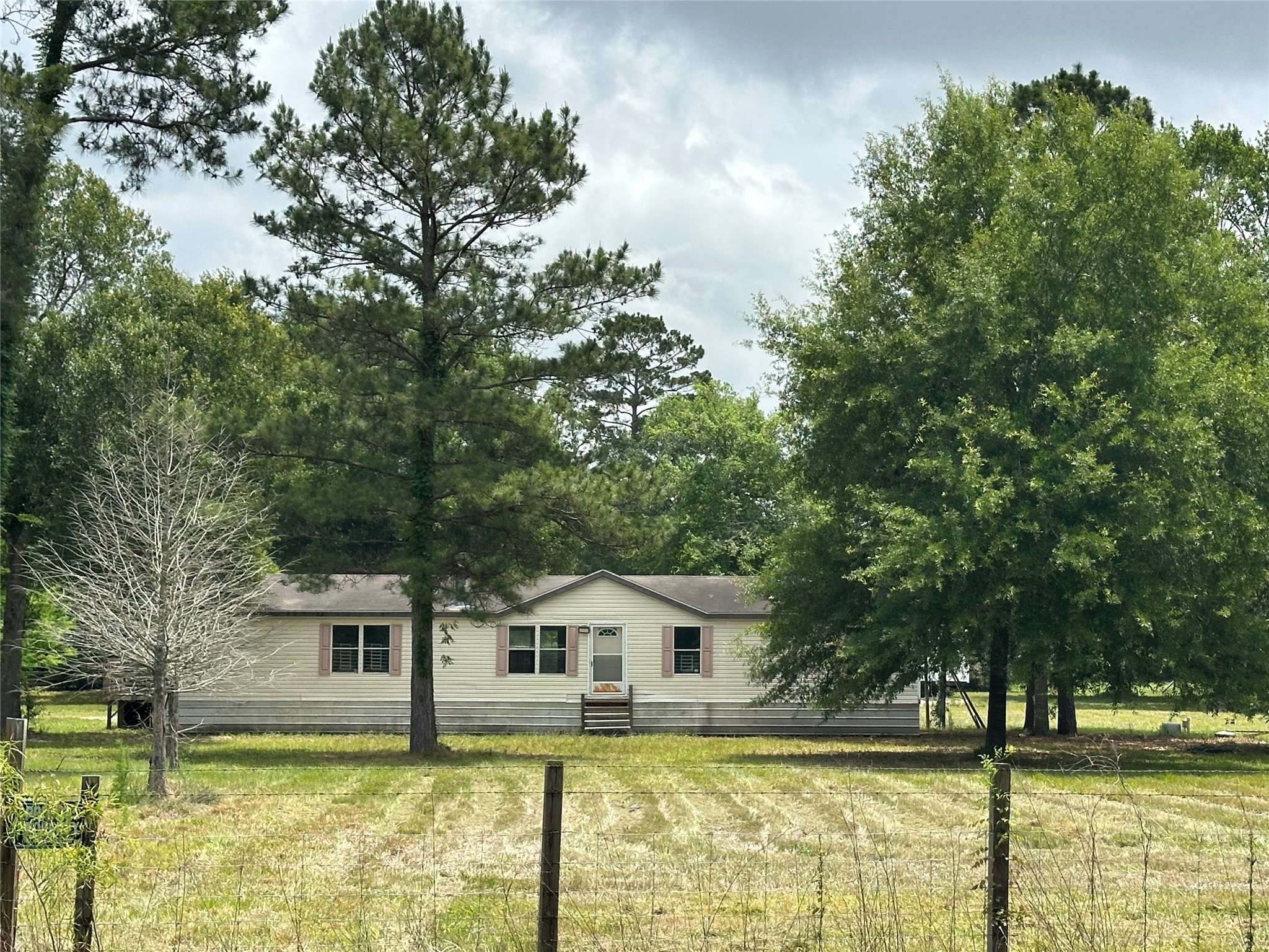2229 Meekins Road Cleveland, TX 77328 - Photo 1 of 48 a front view of a house with a garden and tree