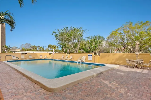 a view of a swimming pool with a lawn chairs