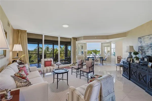 a living room with furniture and large windows