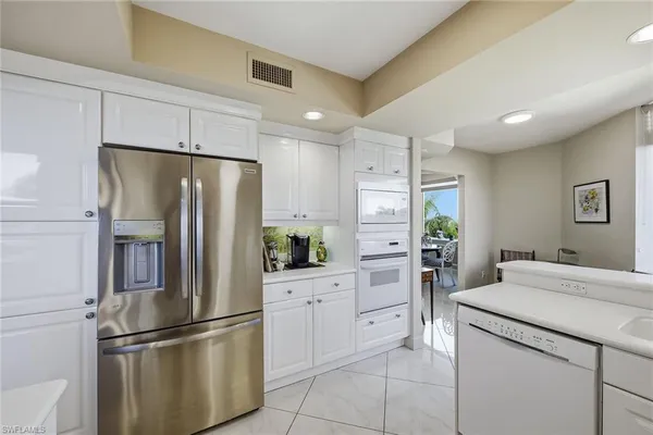 a kitchen with stainless steel appliances a refrigerator sink and stove
