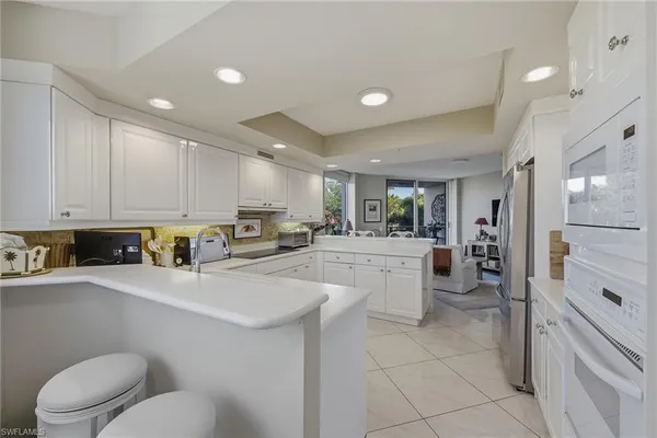 a kitchen with refrigerator and cabinets