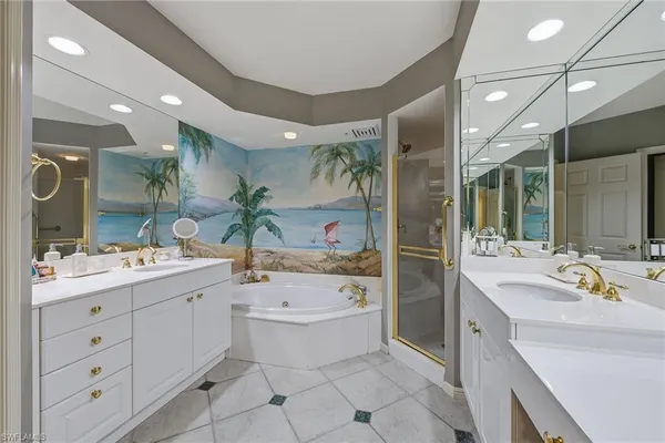 a bathroom with a sink a tub and a mirror