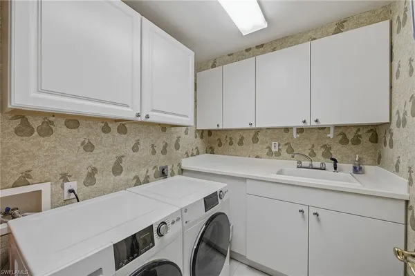 a view of a kitchen counter space a sink and dishwasher